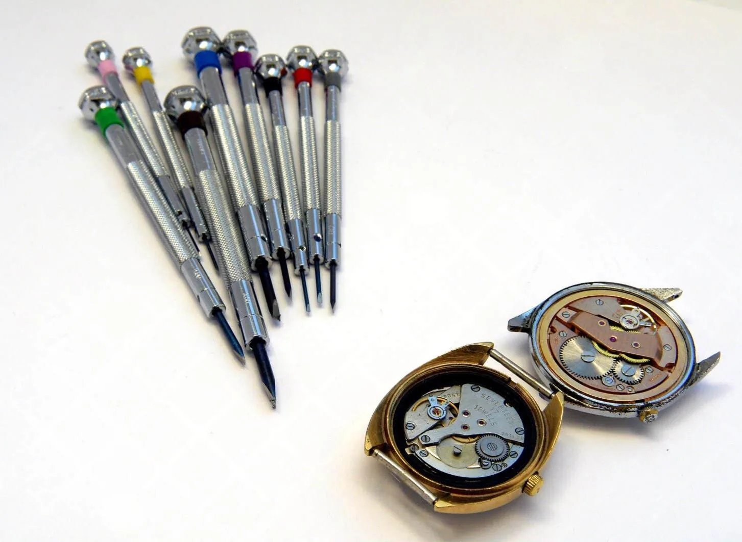 Close-up view of precision watch repair screwdrivers arranged neatly